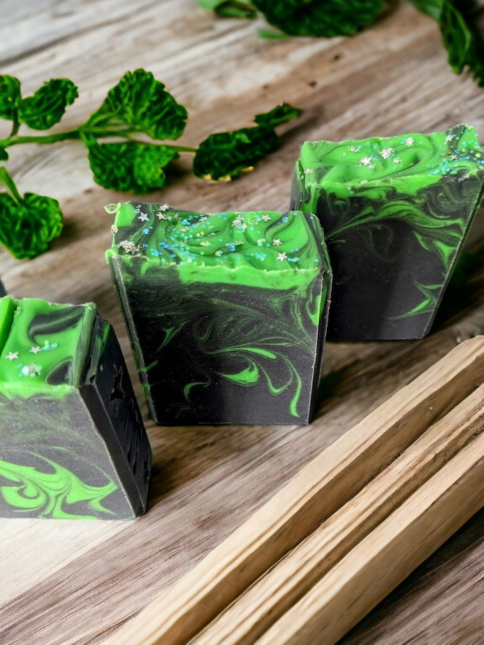 Up your skin care game with this handcrafted, skin nourishing 'Aurora Hemp-ealis', hemp oil and goat milk soap bar.  Black background with a dusting of holographic sparkles with delicate neon green swirls dancing throughout the soap body just like the Aurora Borealis.  Topped with biodegradable star glitter. Fragranced with Agave Bloom fragrance oil.