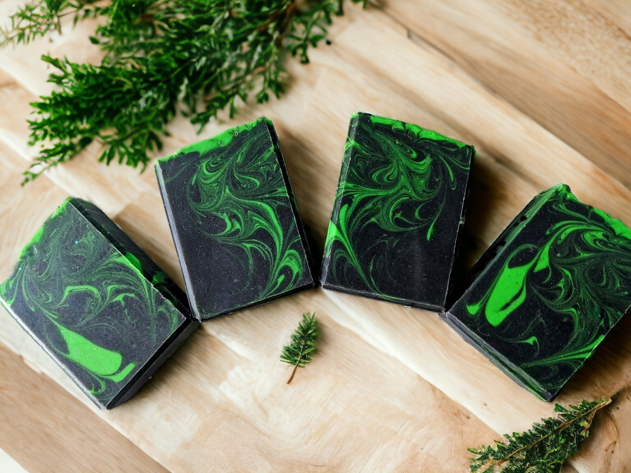 Up your personal care game with this handcrafted, skin nourishing 'Aurora Hemp-ealis', hemp oil and goat milk soap bar.  Black background with a dusting of holographic sparkles with delicate neon green swirls dancing throughout the soap body just like the Aurora Borealis.  Topped with biodegradable star glitter. Fragranced with Agave Bloom fragrance oil.