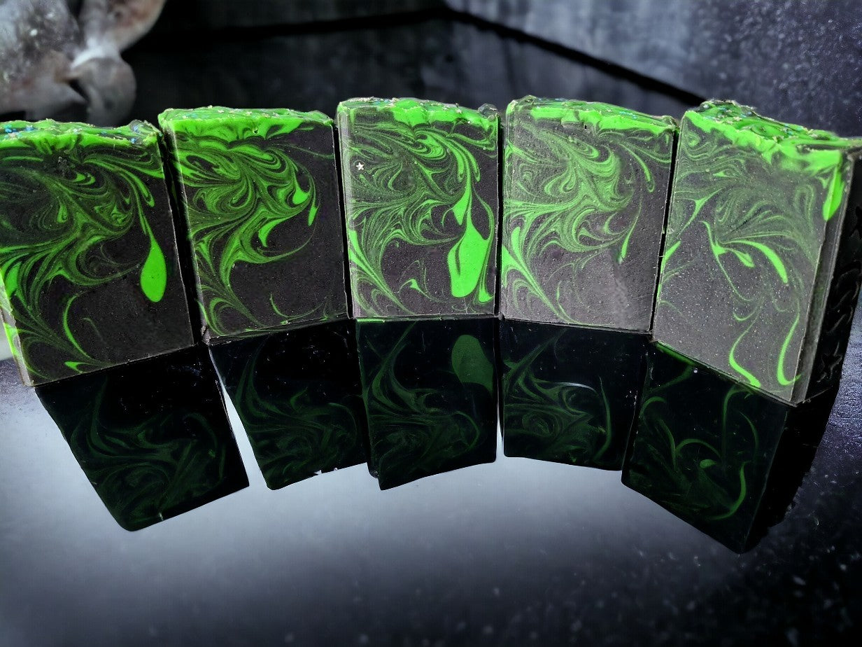 Up your personal care game with this lovingly handcrafted 'Aurora Hemp-ealis', hemp oil and goat milk soap bar.  Black background with a dusting of holographic sparkles with delicate neon green swirls dancing throughout the soap body just like the Aurora Borealis.  Topped with biodegradable star glitter.  Up your skin care game with Aurora-Hemp-ealis.  Fragranced with Agave Bloom fragrance oi