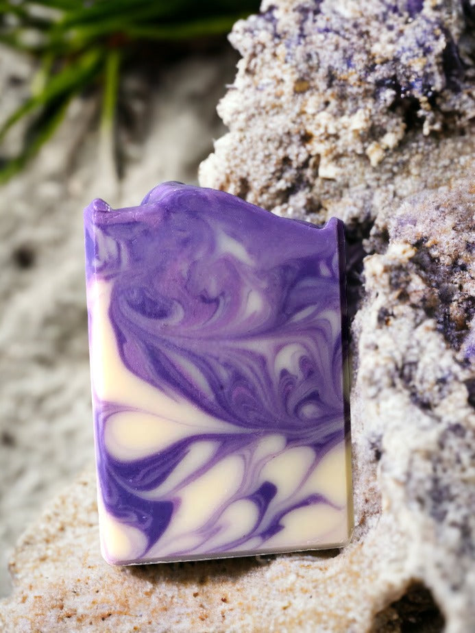 Slide into silky suds with this four butter lavender soap bar. Lovingly handcrafted this bar contains the finest soap making butters that Mother Nature has to off.  Lightly scented with lavender essential oil and delicate swirls in shades of purple and cream, you'll be feeling fresh and fabulous after every use!👌