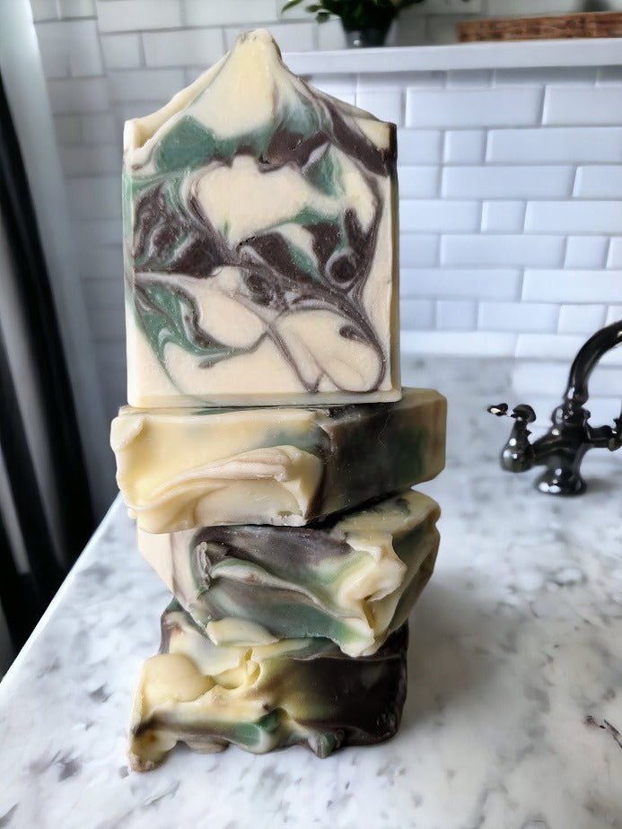 Unlock the magical power of a walk in the woods with our Forest Fresh - Camouflage luxury butter bar with Pine Scent! Take a walk through the crisp winter air with the soothing scent of evergreen trees.  Enjoy the delightful brown and green swirl design on a cream background, mild exfoliation of the Kaolin clay for a unique, luxurious and refreshing experience. Treat yo' self!