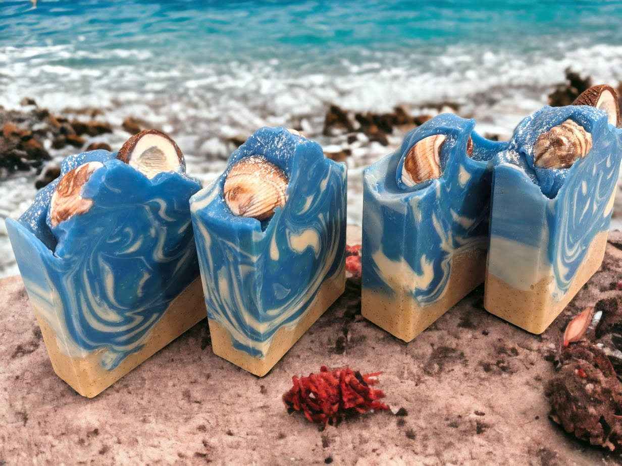 Fun beach-themed soap bar.  Handcrafted with all-natural, nourishing butters like shea, cocoa, mango and kokum. The fun soapy decorations include a half coconut and realistic shells and bright colors will transport you right to the Caribbean, no matter where you are! Enjoy a luxurious, 'Coconut Paradise' fragrant lather each time you wash, and get ready to treasure the summer vibes all year round.