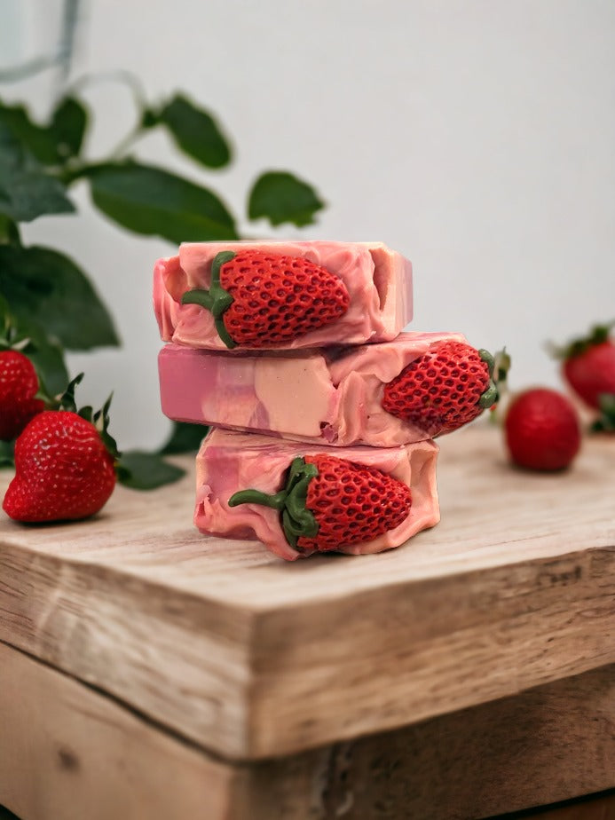 Enjoy the scent fresh picked strawberries with our luxurious Butter Soap Bar! This delightful 4 butter strawberry bar will make you feel like you're right in the middle of a strawberry patch. Topped with a soap strawberrry and a body of red and cream swirls, this handcrafted soap bar is loaded with skin lovin' ingredients, your skin will feel refreshed with a soft silky finish.  Enjoy a fresh, fruity pick-me-up today!