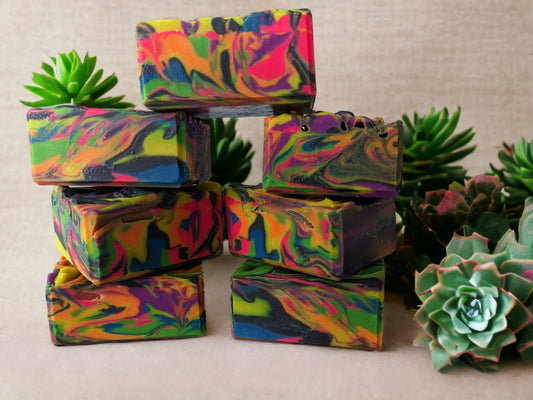 Our handcrafted neon soap bar is bright and bold, featuring an eye-catching neon spin swirls of pink, blue, orange, green, yellow and purple throughout the bar. Tussah Silk, Rice Bran and Avocado oils give this soap a creamy and dreamy texture.  Uncover how the soap design changes as you use it. Who knew soap could be this exciting? 