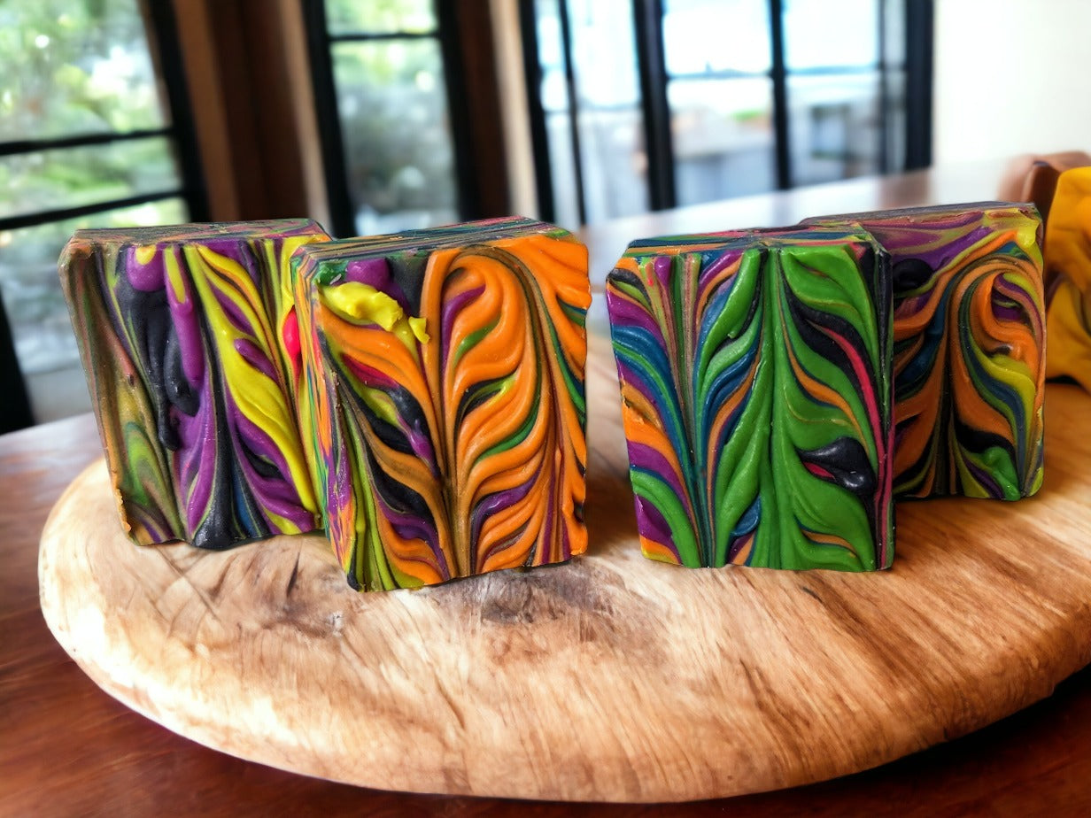 Our small batch neon soap bar is bright and bold, featuring eye-catching neon spin swirls of pink, blue, orange, green, yellow and purple throughout the bar. Handcrafted in small batches, Tussah Silk, Rice Bran and Avocado oils give this soap a wonderful and creamy texture.  Uncover how the soap design changes as you use it.