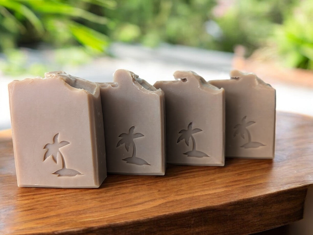 Tan soap with a Palm Tree stamp, enriched with shea, cocoa, mango, and kokum butters. Creamy lather with a light oatmeal, milk, and honey fragrance. Leaves skin soft and refreshed. Perfect for your skincare routine!