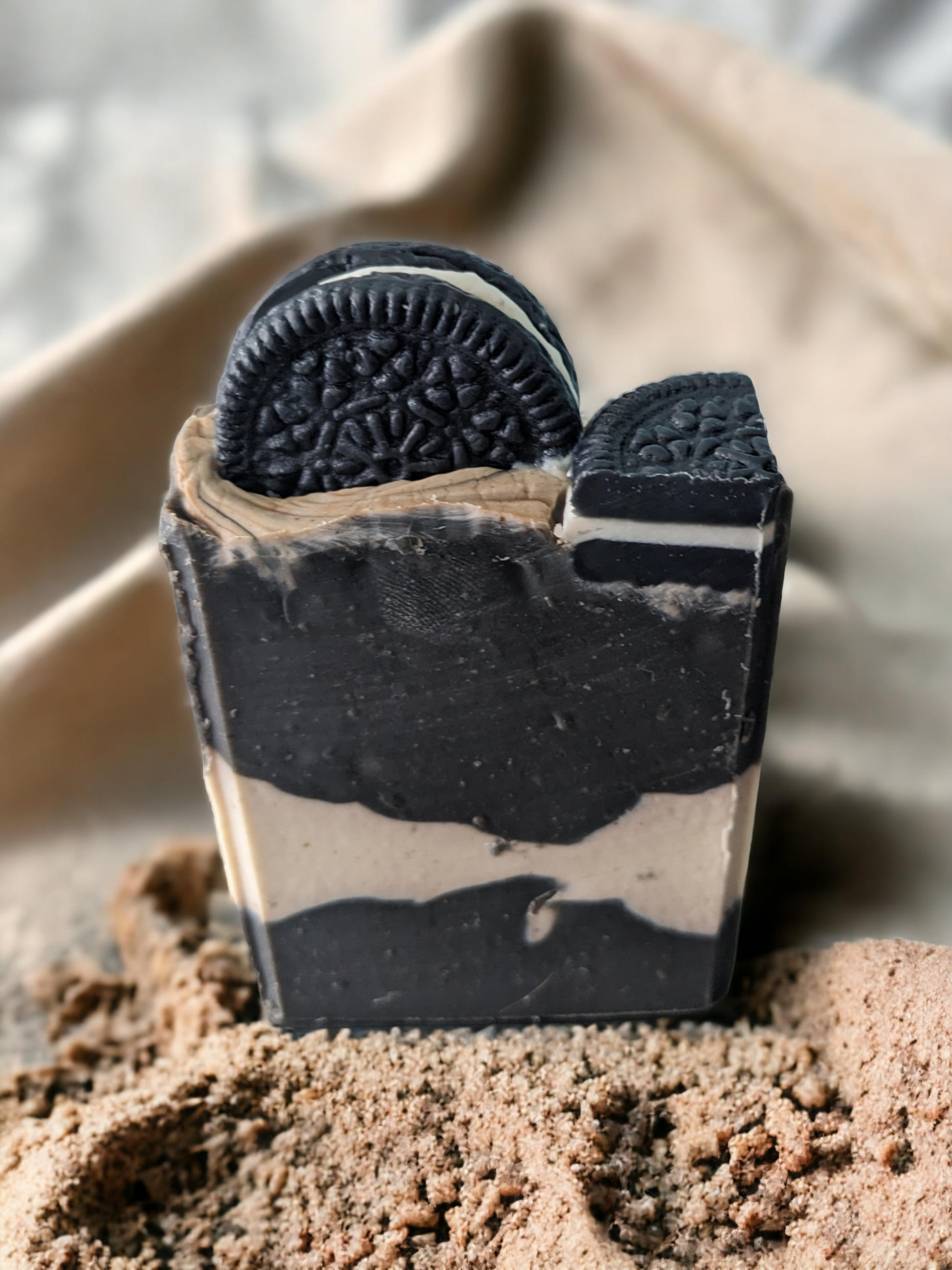 Our Cookies & Cream! 4 butter, handcrafted bar soap will have you feelin' like a kid again! The top of this soap bar is decorated with 'oreo like' cookies and cookie pieces.  The body has layers of black and white. It’s a creamy mix of skin lovin' natural ingredients that will leave your skin happy with a delightfully soft finish. With a delicious vanilla scent, Activated Charcoal and the added luxury of silk, goat milk, mango, shea & cocoa butter, It' time for a cookie party!