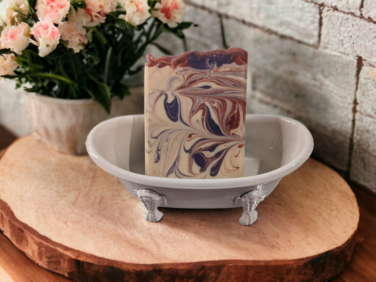 Self-draining, decorative soap holder in the shape of a vintage clawfoot bathtub.  Metal with ceramic coating.