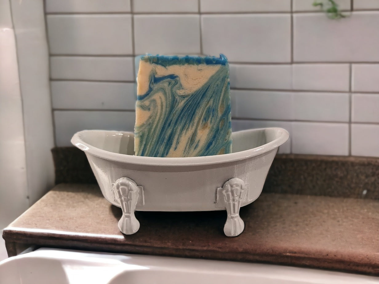 Self-draining, decorative soap holder in the shape of a vintage clawfoot bathtub.  Metal with ceramic coating.