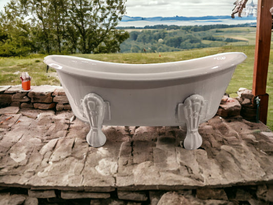 Self-draining, decorative soap holder in the shape of a vintage clawfoot bathtub.  Metal with ceramic coating.