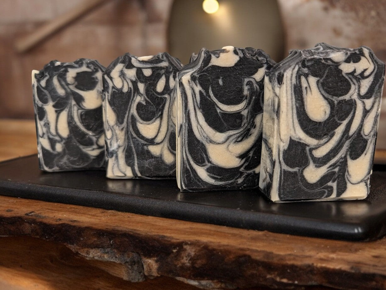 All natural, black and off white sea moss, coconut milk and activated charcoal bar soap. Fragranced with Eucalyptus and Lemon essential oils.  Super rich and bubbly lather, gentle on skin.  This artisan soap bar is a must have for your shower routine!  AI tells us that 'Sea moss soap is renowned for its myriad skin health benefits, attributed to the abundant minerals and vitamins in sea moss.' Go ahead and search for it in your preferred internet browser to learn more!