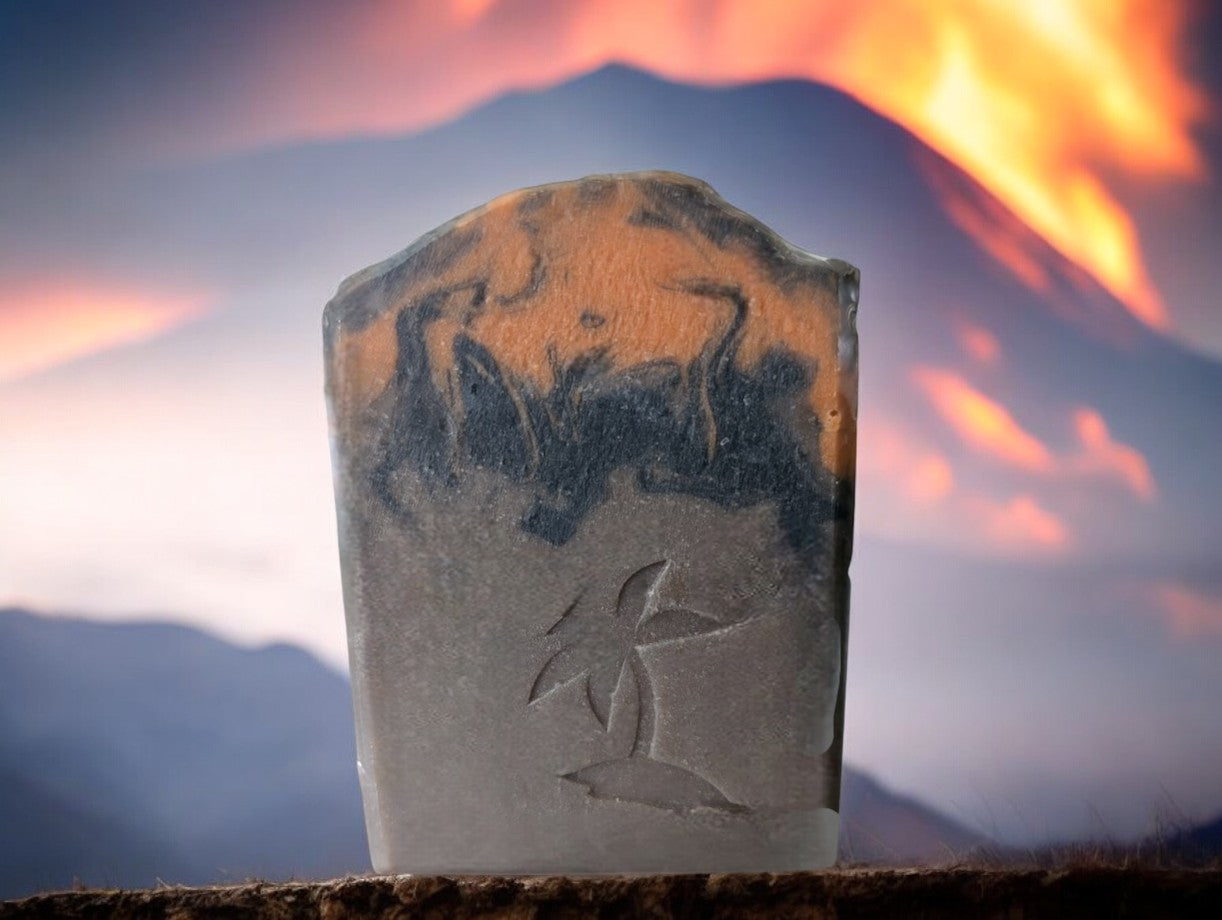 Brown volcano goat milk soap adorned with orange and black soap (lava).This is a big bubble bar with a light luxurious lather. A must have for shower care product collection. Similar to Capri Blue®'s Volcano.