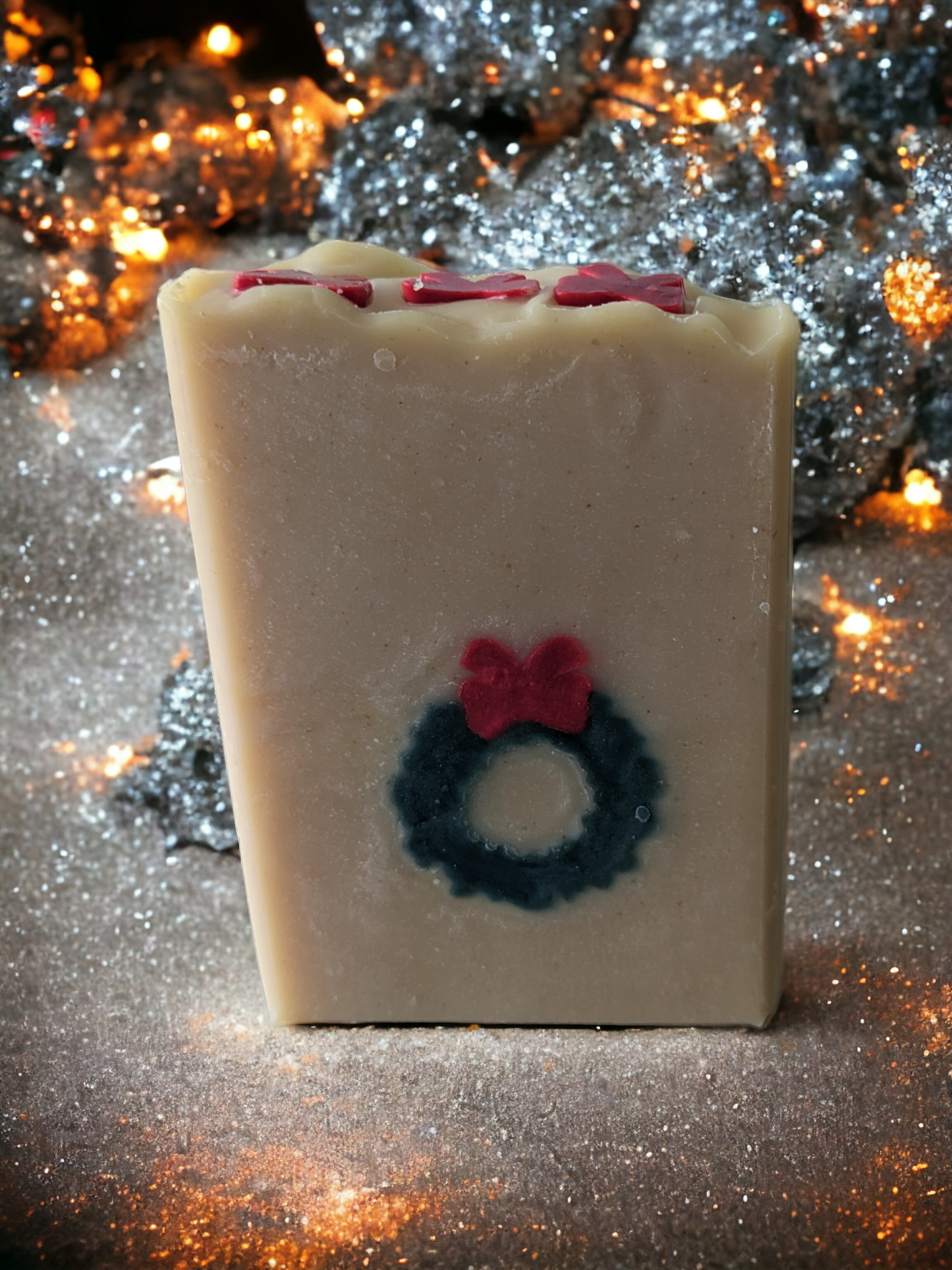 Delightful handmade, decorative Christmas soap bar.  This bar features a green wreath and red ribbon that goes through the entire soap bar (from front to back)!  Scented with Evergreen Forest fragrance oil, it's perfect for bringing that special festive something to any bathroom! So, ‘tis the season to be merry—get your Wreath of Green soap bar today!