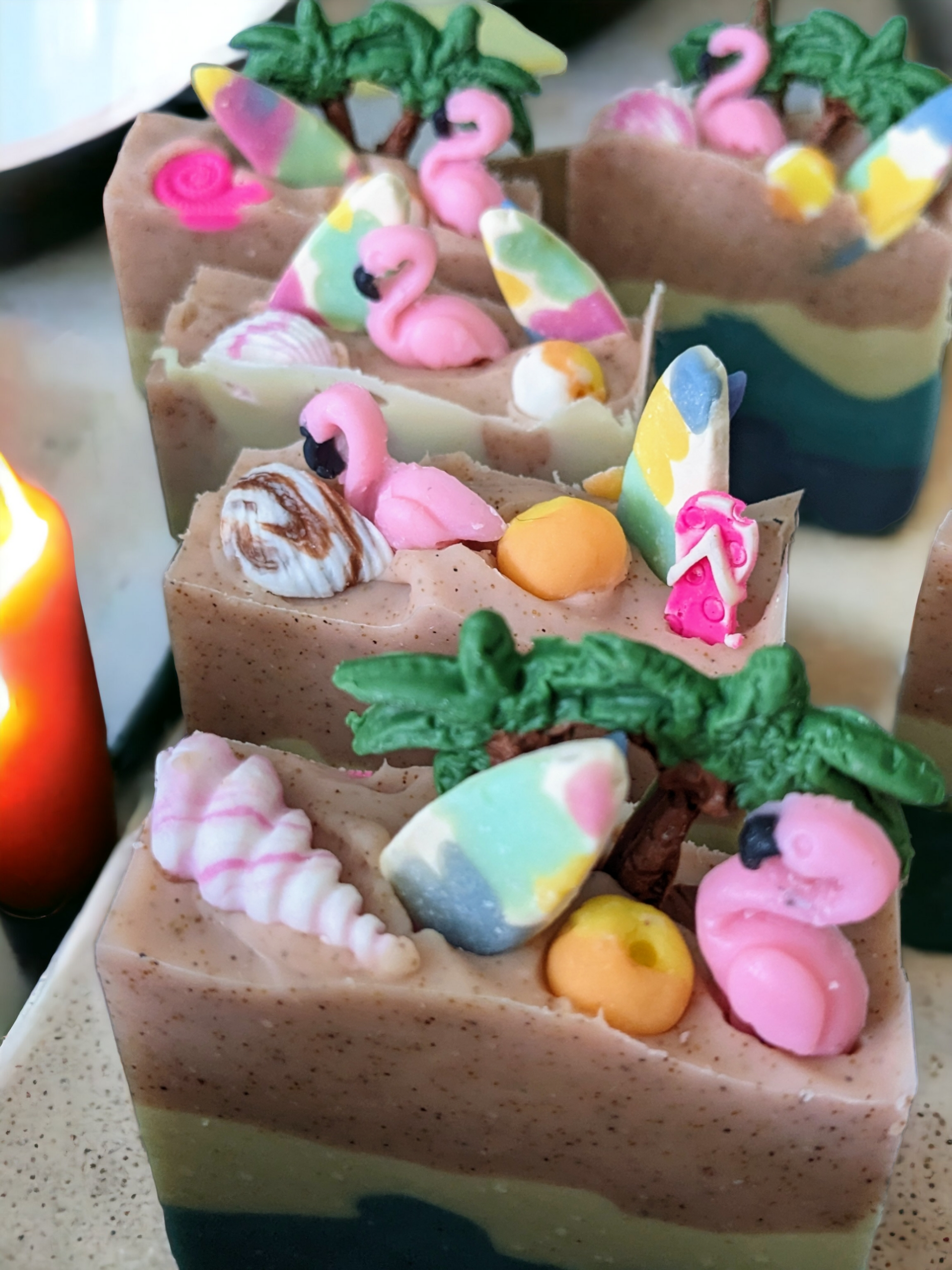 Luxurious beach themed butter soap bar with delightful beach decorations like Palm Trees, surf boards sea shells and beachballs.  Scented with Pink Sangria, this soap was inspired by Pink Sands Beach in the Bahamas.