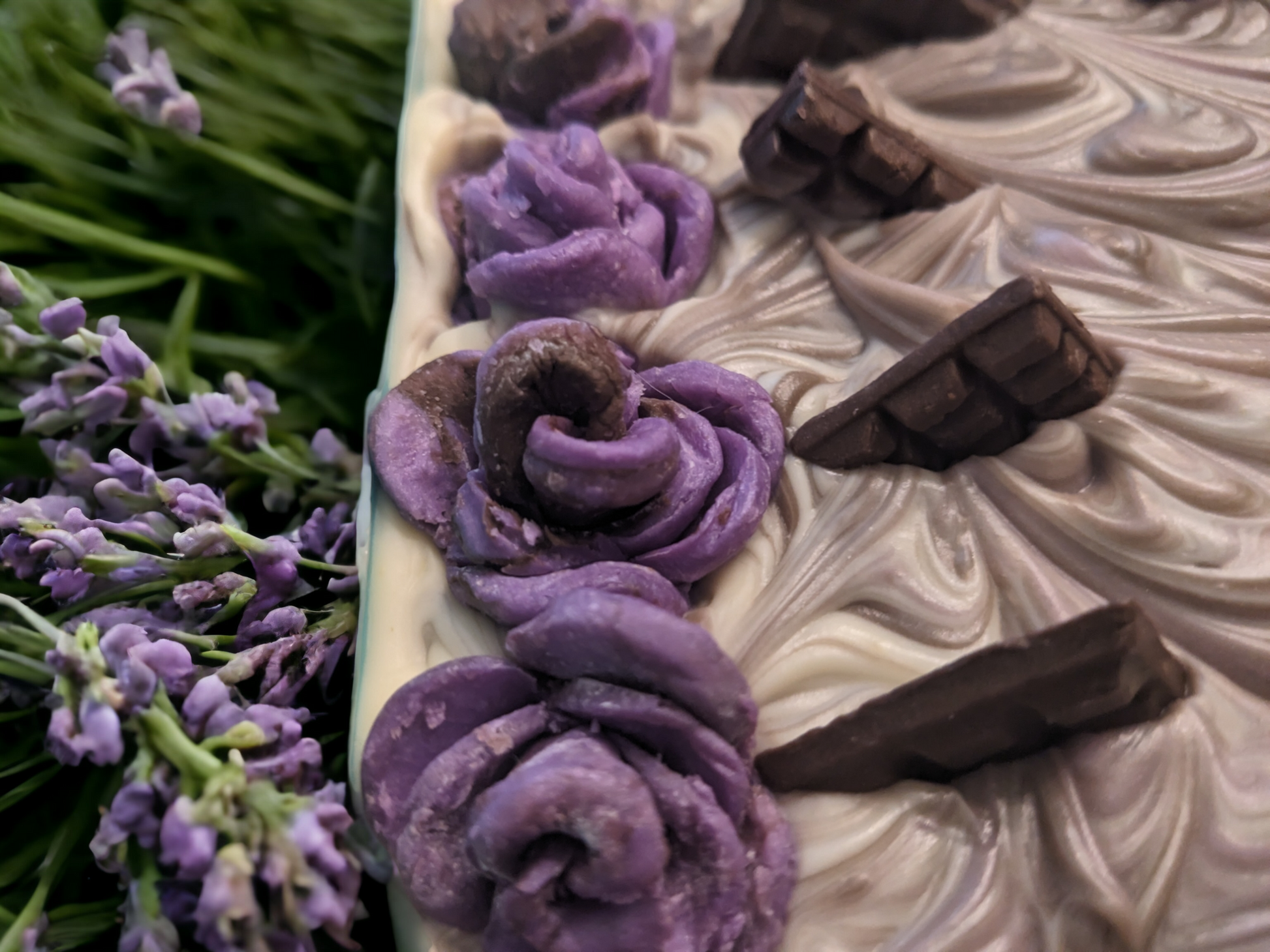 Revel in the luxury of this artisanal soap bar made with rich and velvety butters! Super-soft billowy swirls create go through the soap bar while chocolate lavendar roses and chocolate bar bitsadorn the top of this soap.  With a sumptuous creamy lather, the dreamy mix of chocolate and lavender fragrance will take you to a heavenly place. Don't miss out on this dreamy soap bar; it's an absolute must!