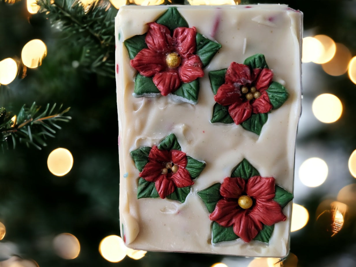 Take your holiday decor to the next level of festive with the Poinsettia Pizzazz Christmas soap!  The soap is layered with Christmas green and off white with green, red and white soap sprinkles.  The top of the soap is adorned with beautiful soap poinsettias.  This decorative holiday soap will add a "ho-ho-hole lot" of fun and charm to your everyday routine during the holidays. 