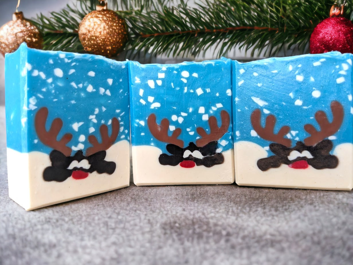 Fun holiday bar soap with a delightful reindeer peeking over a snowbank in a snowy scene.  Loaded up with skin loving ingredients and scented with 'Peppermint Stick', you're sure to get a holly jolly clean with this fun soap bar!