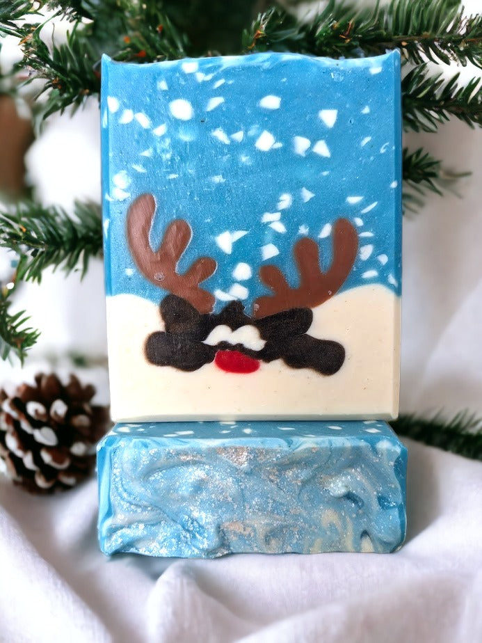 This Peeking Reindeer Christmas Soap will have you singing Joy to the World! This cute tallow bar soap features an adorable reindeer peeking over a snowbank in a snowy scene.  This little guy is sure to delight your family and guests.  Lather up with loads of delicious peppermint stick scented bubbles and get ready to have a holly jolly holiday. 'Tis the season for clean and merry skin!