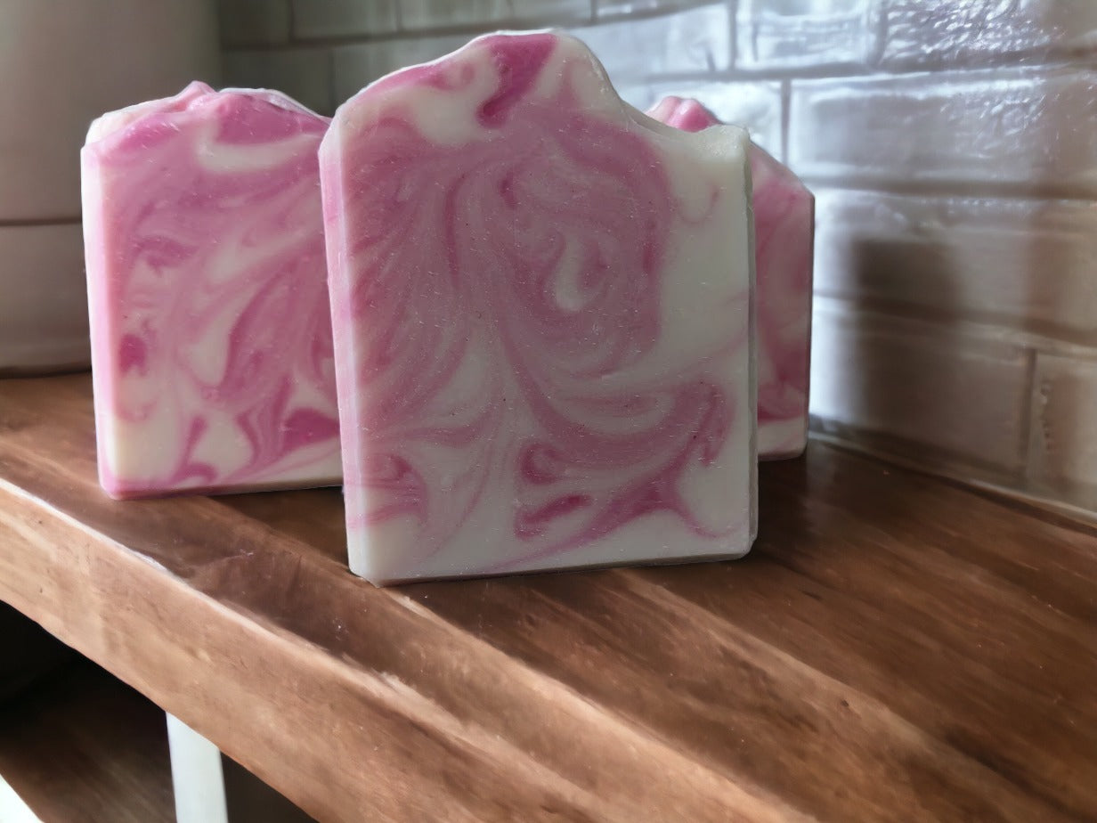 Marvel at the sophisticated handcrafted swirly design of this Pink and white Rose Quartz bar soap! You'll discover a luscious lather made with Green Tea Seed Oil and Tussah Silk and skin loving oils. Whether you prefer scented with Rose Quartz Fragrance Oil. Dive into a soapy oasis of delight!