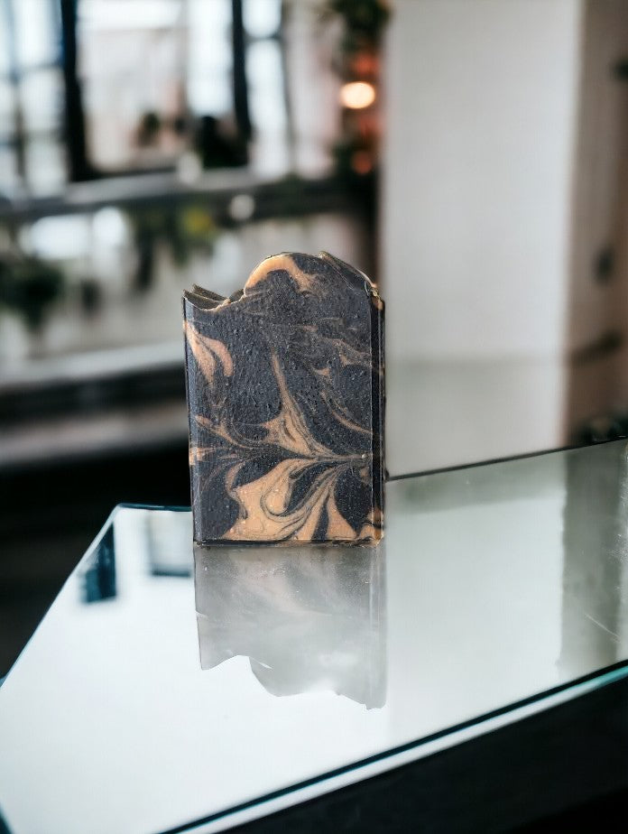 Black soap with gold swirls. Healthy and skin loving ingredients include Activated Charcoal, Kaolin Clay, Colloidal Oats and Coconut milk. Fragranced with Lavender and Black Amber Fragranced Bar Soap. Cheryl's Southern Soapery