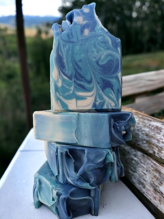 Give your body the royal treatment with our luxurious Blackberry Vanilla soap bar!  This delightful unisex bar features whispy swirls in shades of blue and white.  Made with the finest butters and oils Mother Nature has to offer, this bar soap is sure to leave you feeling positively pampered. Give the royal scrub a try today!