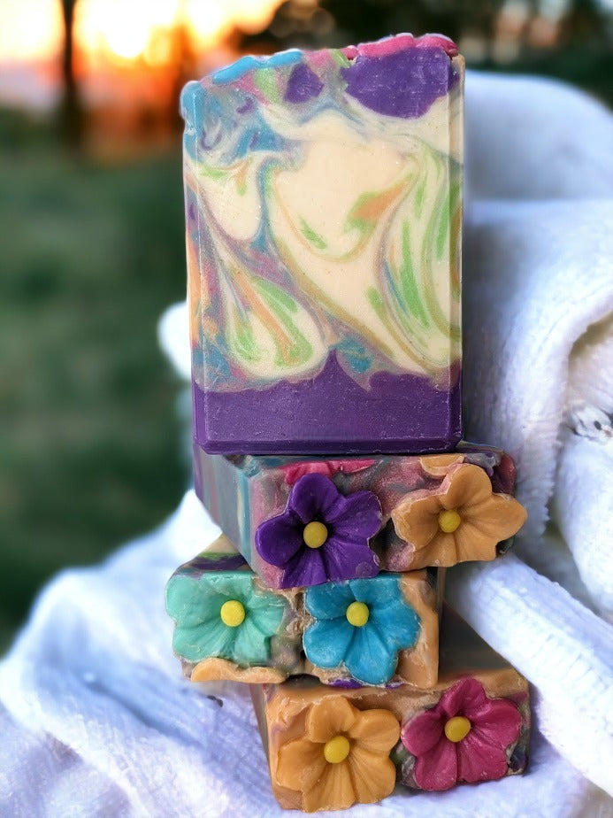 Spring soap scented with midnight peonies.  Soap flowers in spring colors adorn the top of this luxury soap bar! Gentle swirls throughout the soap in the same color as the flowers in purple, pink orange, green and caribbean blue. Handcrafted with skin-loving Shea, Mango, Cocoa and Kokum butters, you'll feel as fresh as a spring morning! And the gorgeous soap flowers and swirl design make it the perfect gift for any occasion!