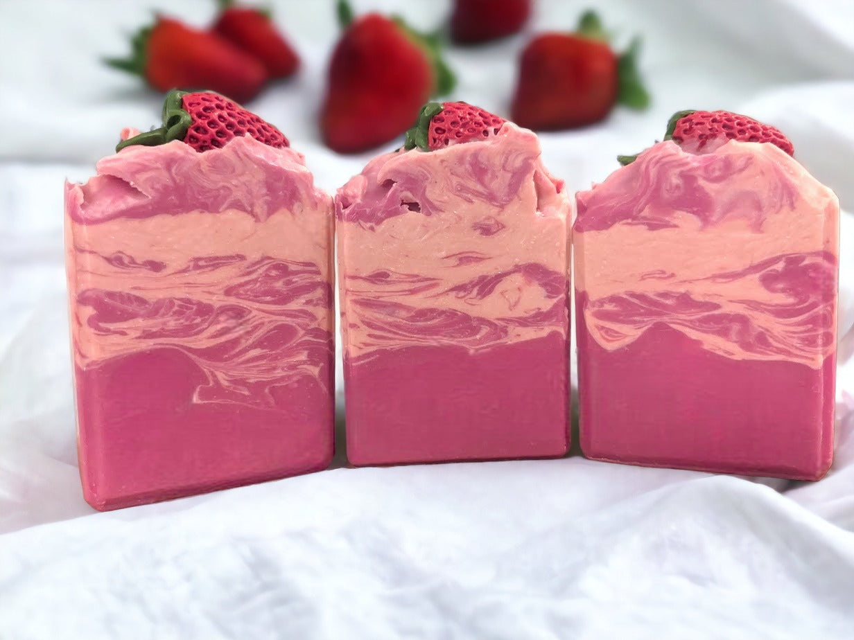 Enjoy the scent fresh picked strawberries with our luxurious Butter Soap Bar! This delightful 4 butter strawberry bar will make you feel like you're right in the middle of a strawberry patch. Topped with a soap strawberrry and a body of red and cream swirls, this handcrafted soap bar is loaded with skin lovin' ingredients, your skin will feel refreshed with a soft silky finish.